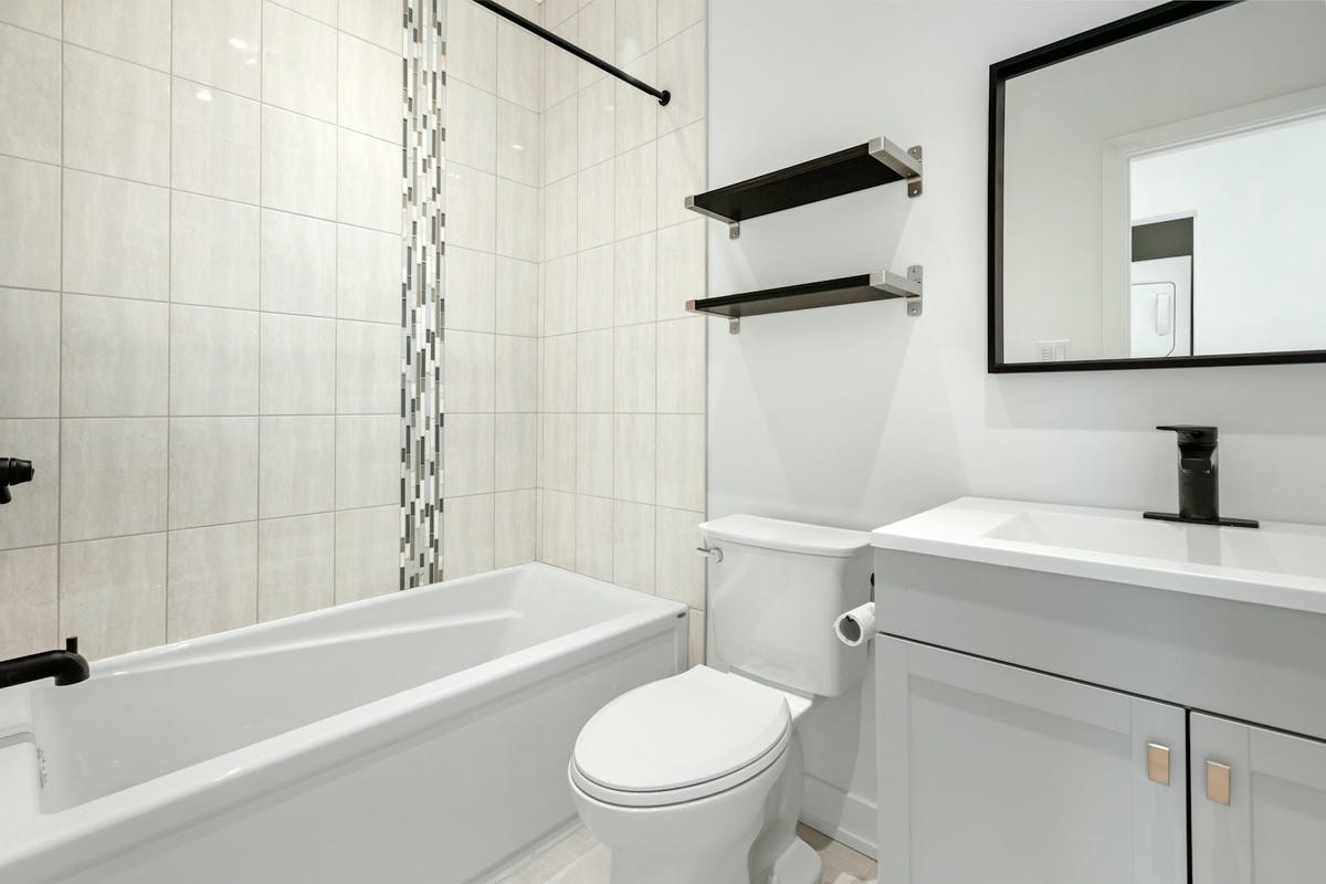 a bathroom with a tub toilet and sink